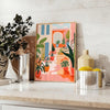 Design floral vintage com flores laranja e cinza em um fundo texturizado - sobre uma bancada com eucalipto e uma taça de limões