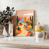 Colorful flower print with green and orange tones in a trendy style - styled on a counter with eucalyptus and a bowl of lemons