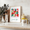 Abstract composition of fruits in green and red hues - styled on a counter with eucalyptus and a bowl of lemons