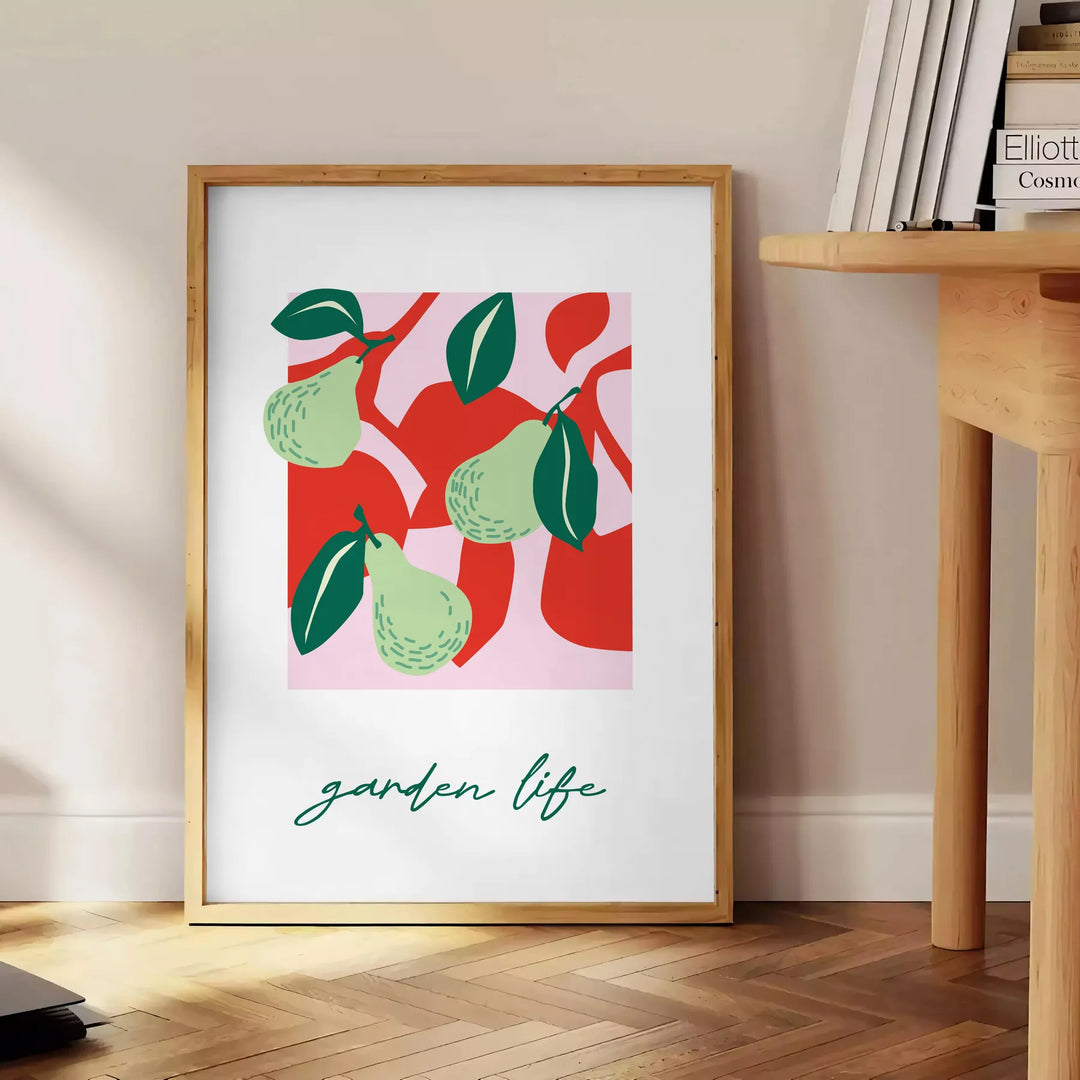 Abstract composition of fruits in green and red hues - beside a round wooden side table with books