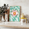 Abstract design with swirling green and orange shapes resembling a playful cosmic scene - styled on a counter with eucalyptus and a bowl of lemons