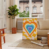 Abstract representation of space with bold green and orange colors - in a Parisian living room with a sofa and a fig plant