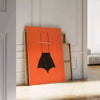 A playful design featuring abstract shapes in black and orange - leaning on a herringbone floor against a white panelled wall