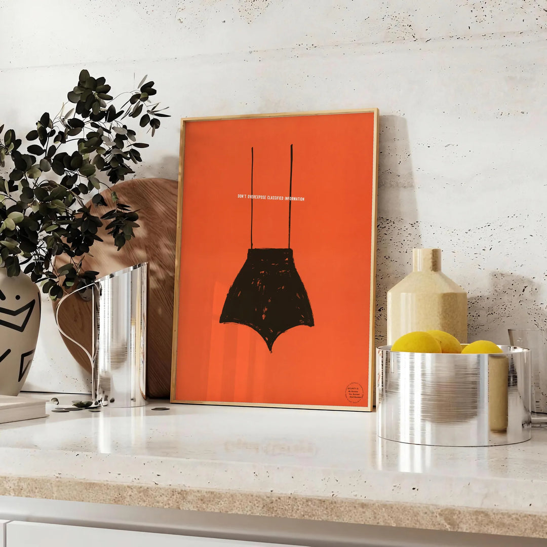 A playful design featuring abstract shapes in black and orange - styled on a counter with eucalyptus and a bowl of lemons