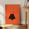 A playful design featuring abstract shapes in black and orange - beside a round wooden side table with books