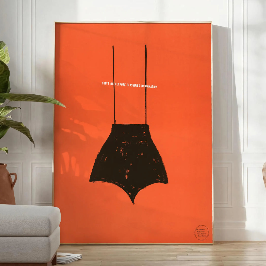 A playful design featuring abstract shapes in black and orange - in a bright minimalist room with a plant and an armchair
