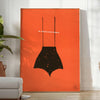 A playful design featuring abstract shapes in black and orange - in a bright minimalist room with a plant and an armchair