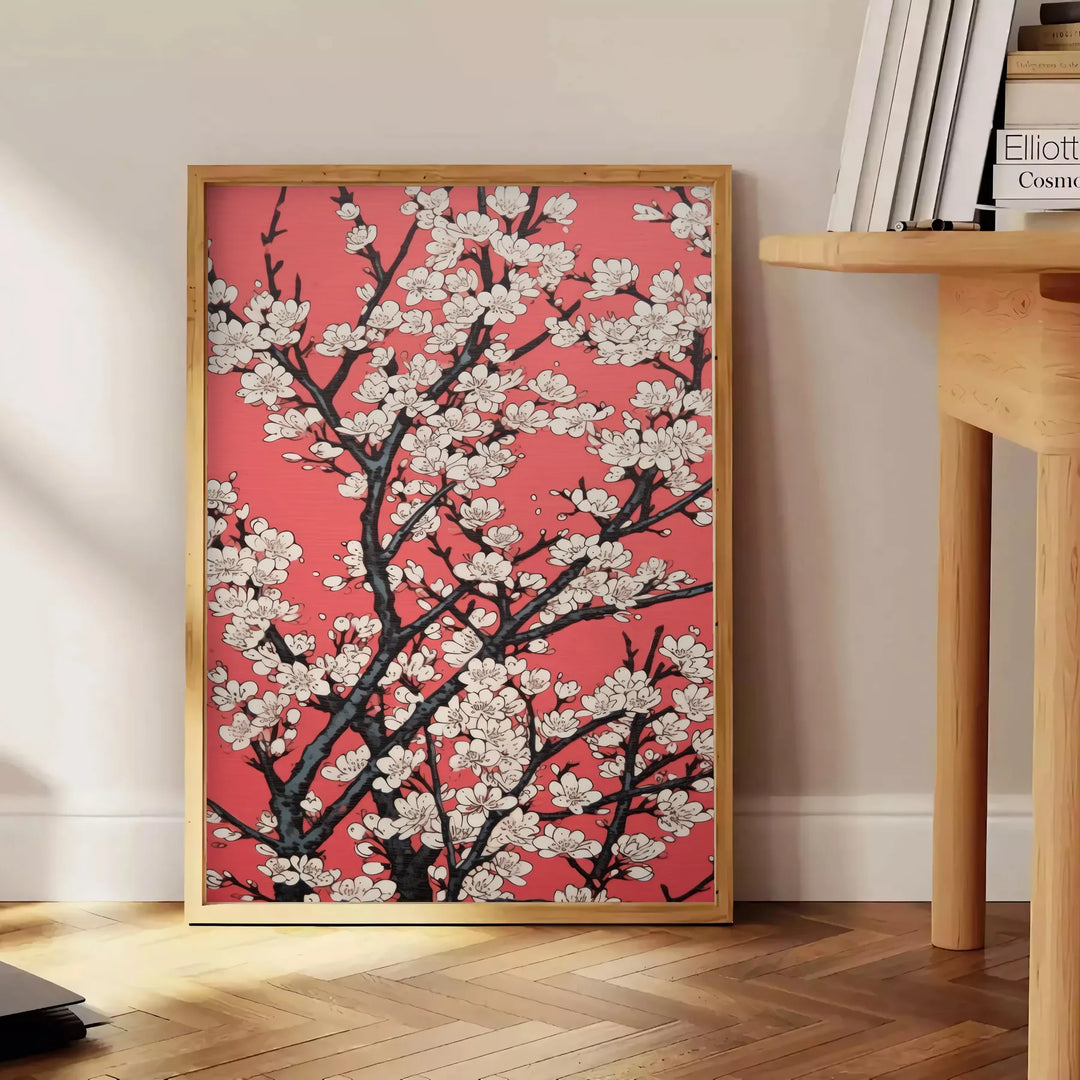 floral garden scene with black and orange tones - beside a round wooden side table with books