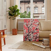 floral garden scene with black and orange tones - in a Parisian living room with a sofa and a fig plant