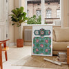 lush green garden with purple flowers in a serene setting - in a Parisian living room with a sofa and a fig plant