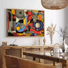Geometric shapes in black and orange on a minimal background - in a Parisian living room with a sofa and a fig plant