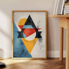 Geometric shapes in orange and blue on a minimal background - beside a round wooden side table with books
