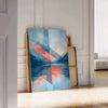 Geometric shapes in orange and blue on a minimal background - leaning on a herringbone floor against a white panelled wall