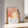 Abstract splash of orange and black depicting a Gin Fizz cocktail - leaning on a herringbone floor against a white panelled wall