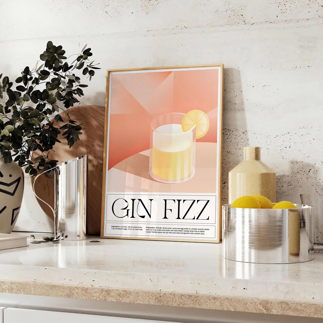Abstract splash of orange and black depicting a Gin Fizz cocktail - styled on a counter with eucalyptus and a bowl of lemons