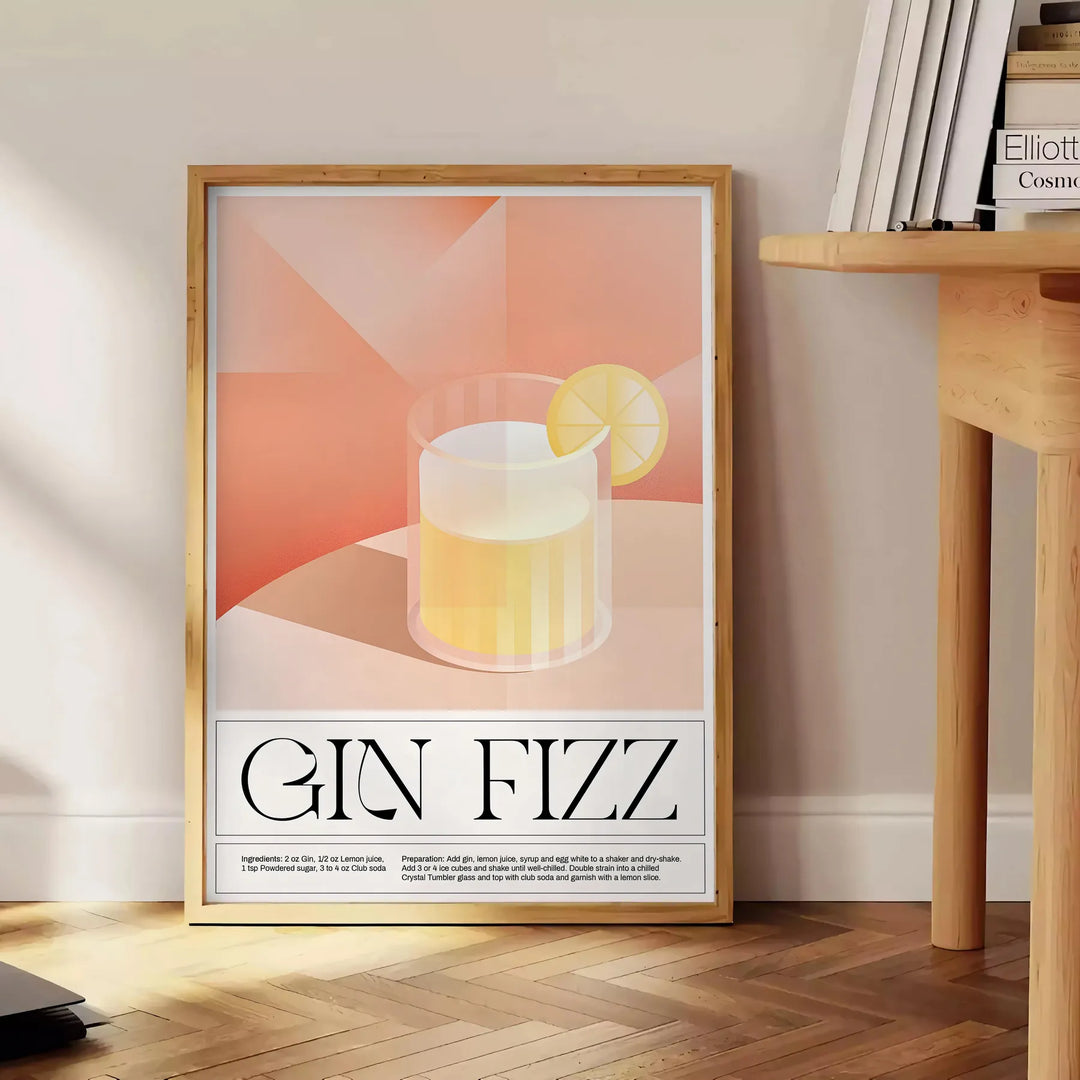 Abstract splash of orange and black depicting a Gin Fizz cocktail - beside a round wooden side table with books