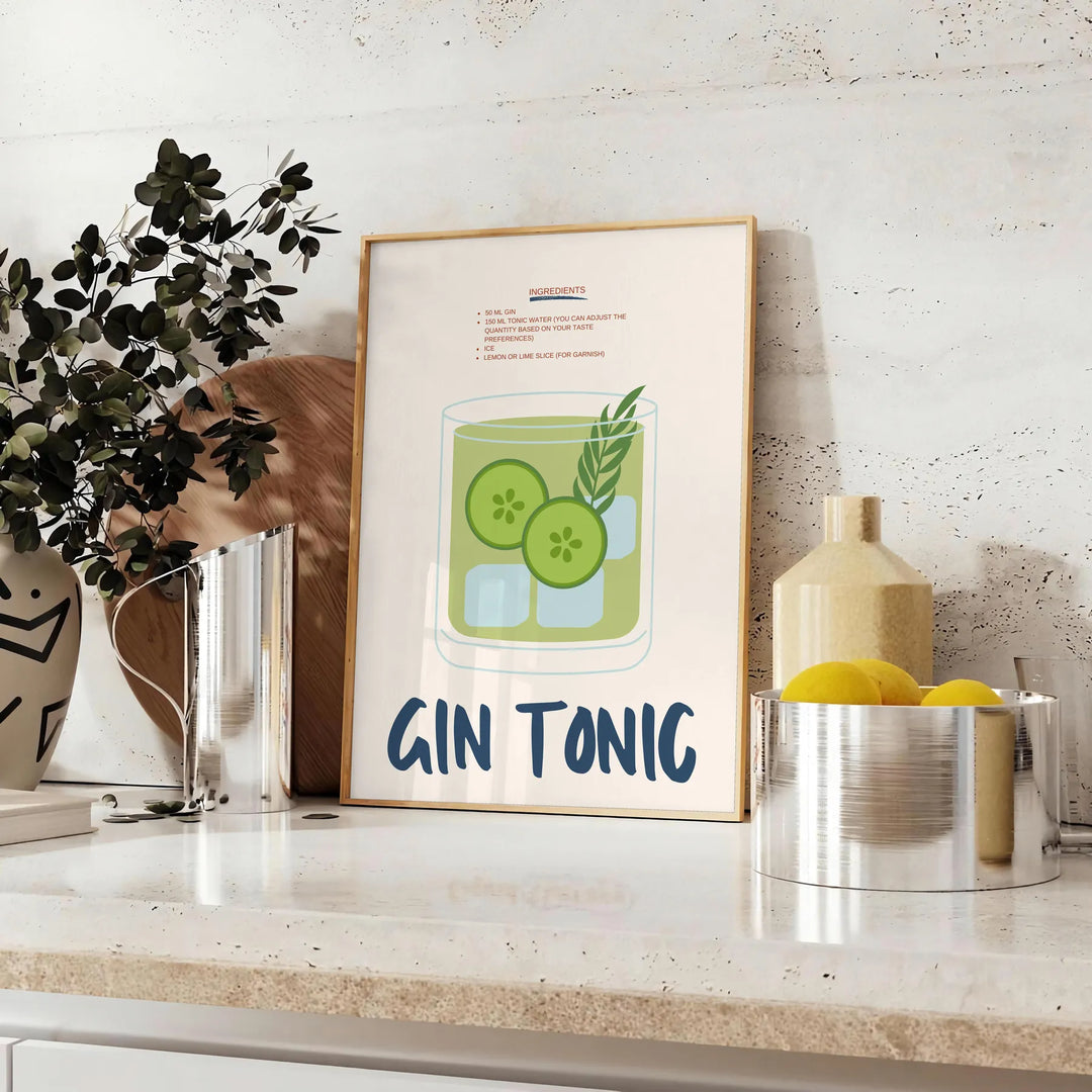 A refreshing gin and tonic with green garnishes on a white background - styled on a counter with eucalyptus and a bowl of lemons