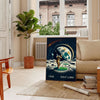 Art Deco poster featuring a golf silhouette under a large moon - in a Parisian living room with a sofa and a fig plant