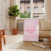 Abstract design with warm brown and red tones featuring motivational text - in a Parisian living room with a sofa and a fig plant