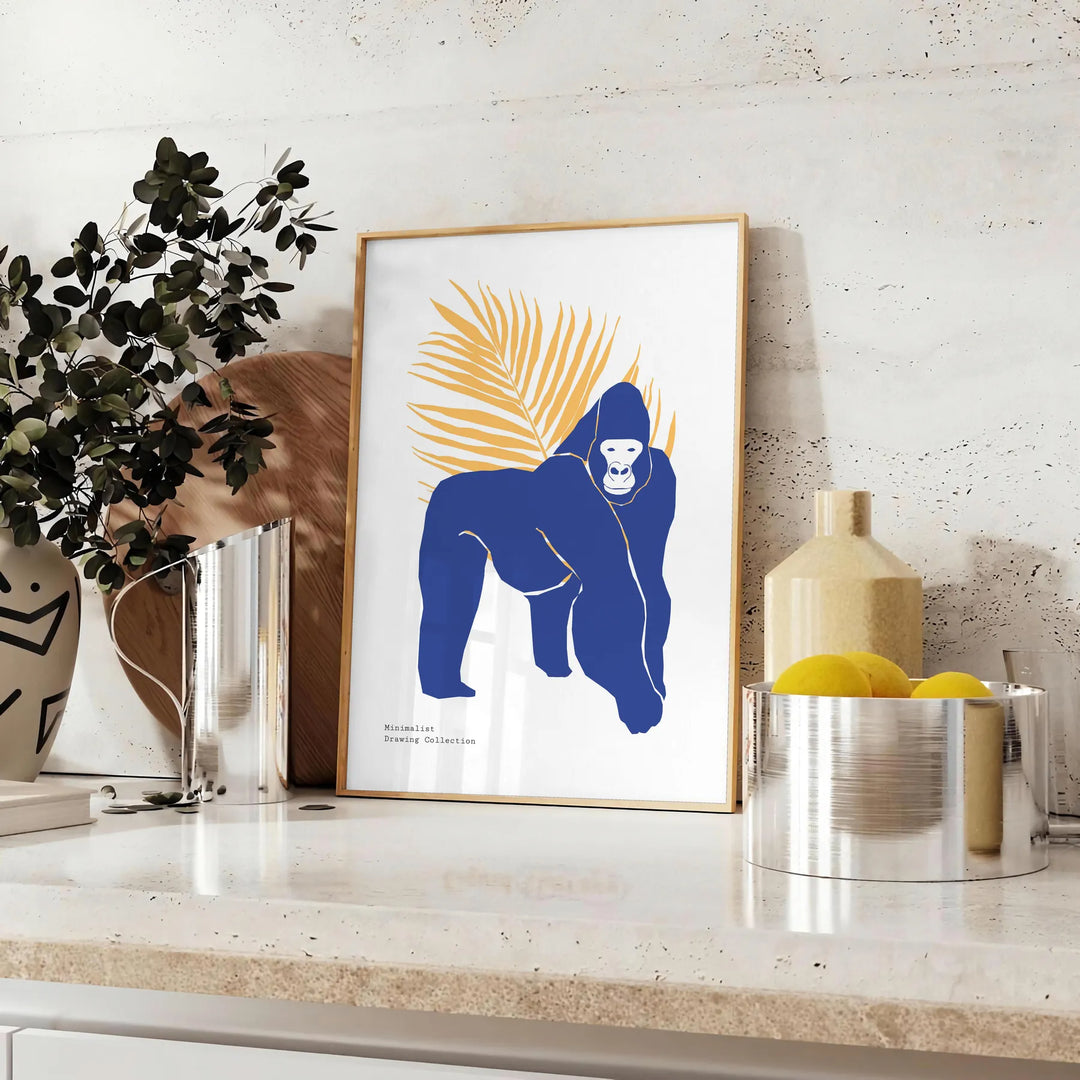 A detailed illustration of a gorilla surrounded by green and blue foliage - styled on a counter with eucalyptus and a bowl of lemons