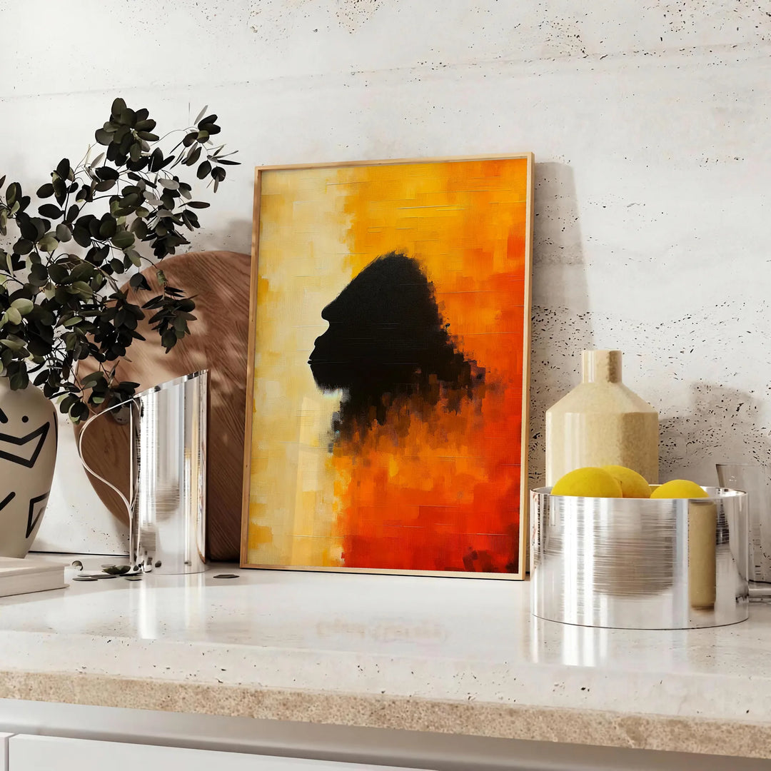 A bold illustration of a gorilla against a background of orange and red hues - styled on a counter with eucalyptus and a bowl of lemons