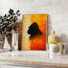 A bold illustration of a gorilla against a background of orange and red hues - styled on a counter with eucalyptus and a bowl of lemons