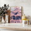 Illustration of the Grand Canyon with warm earthy tones and dramatic rock formations - styled on a counter with eucalyptus and a bowl of lemons