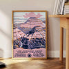 Illustration of the Grand Canyon with warm earthy tones and dramatic rock formations - beside a round wooden side table with books