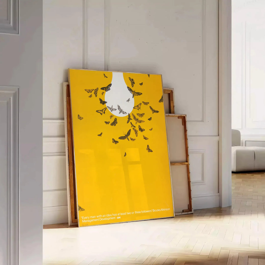Abstract graphic design featuring orange and white space elements - leaning on a herringbone floor against a white panelled wall