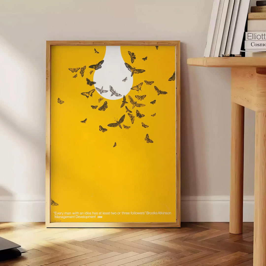 Abstract graphic design featuring orange and white space elements - beside a round wooden side table with books