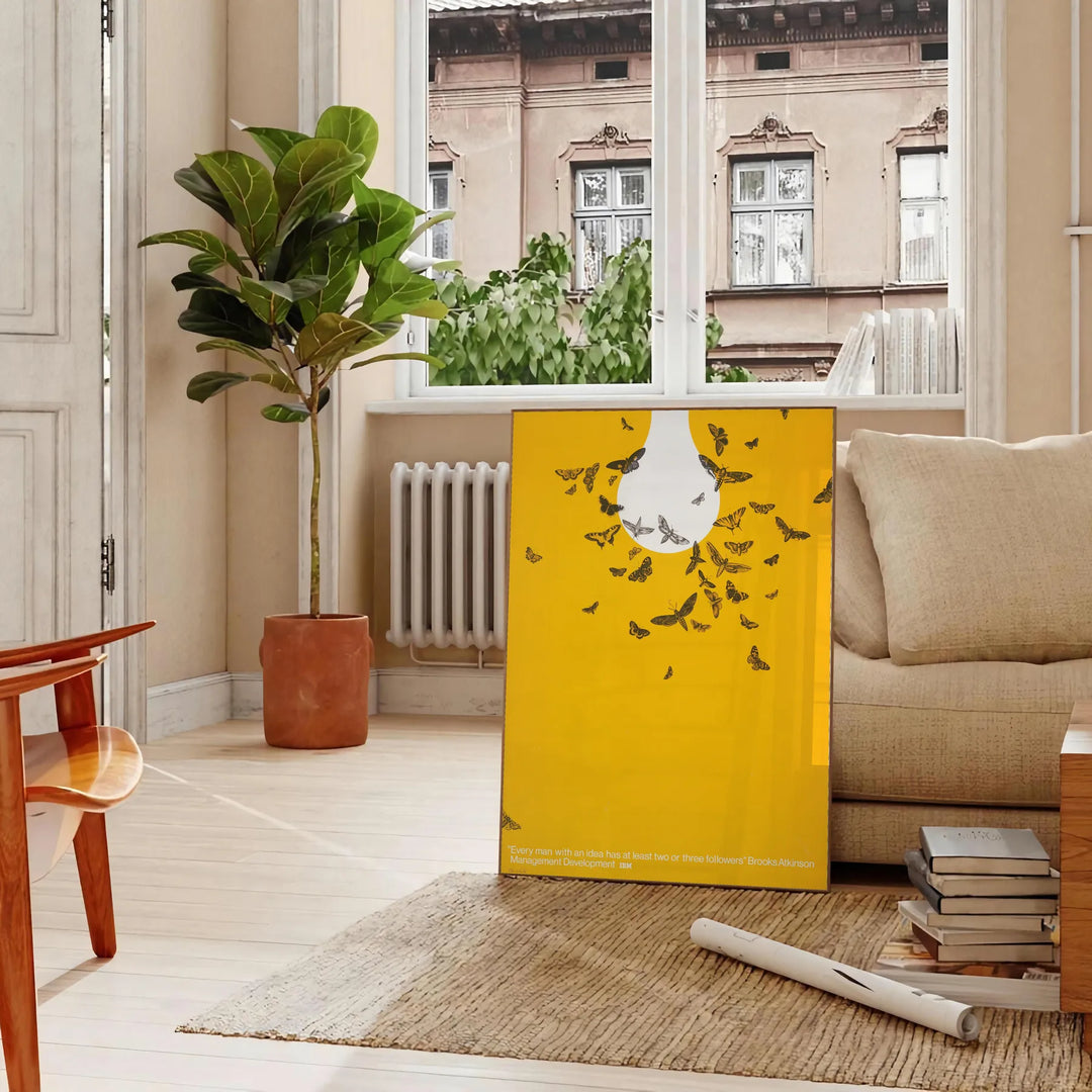 Abstract graphic design featuring orange and white space elements - in a Parisian living room with a sofa and a fig plant