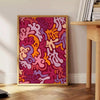 Fluid pattern design in rich browns and oranges resembling a lava lamp - beside a round wooden side table with books
