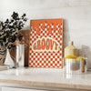 Retro-style poster featuring abstract shapes in orange and brown tones - styled on a counter with eucalyptus and a bowl of lemons