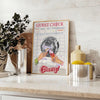 Graphic art print featuring a guest check design in green and orange hues - styled on a counter with eucalyptus and a bowl of lemons