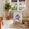 Graphic art print featuring a guest check design in green and orange hues - in a Parisian living room with a sofa and a fig plant