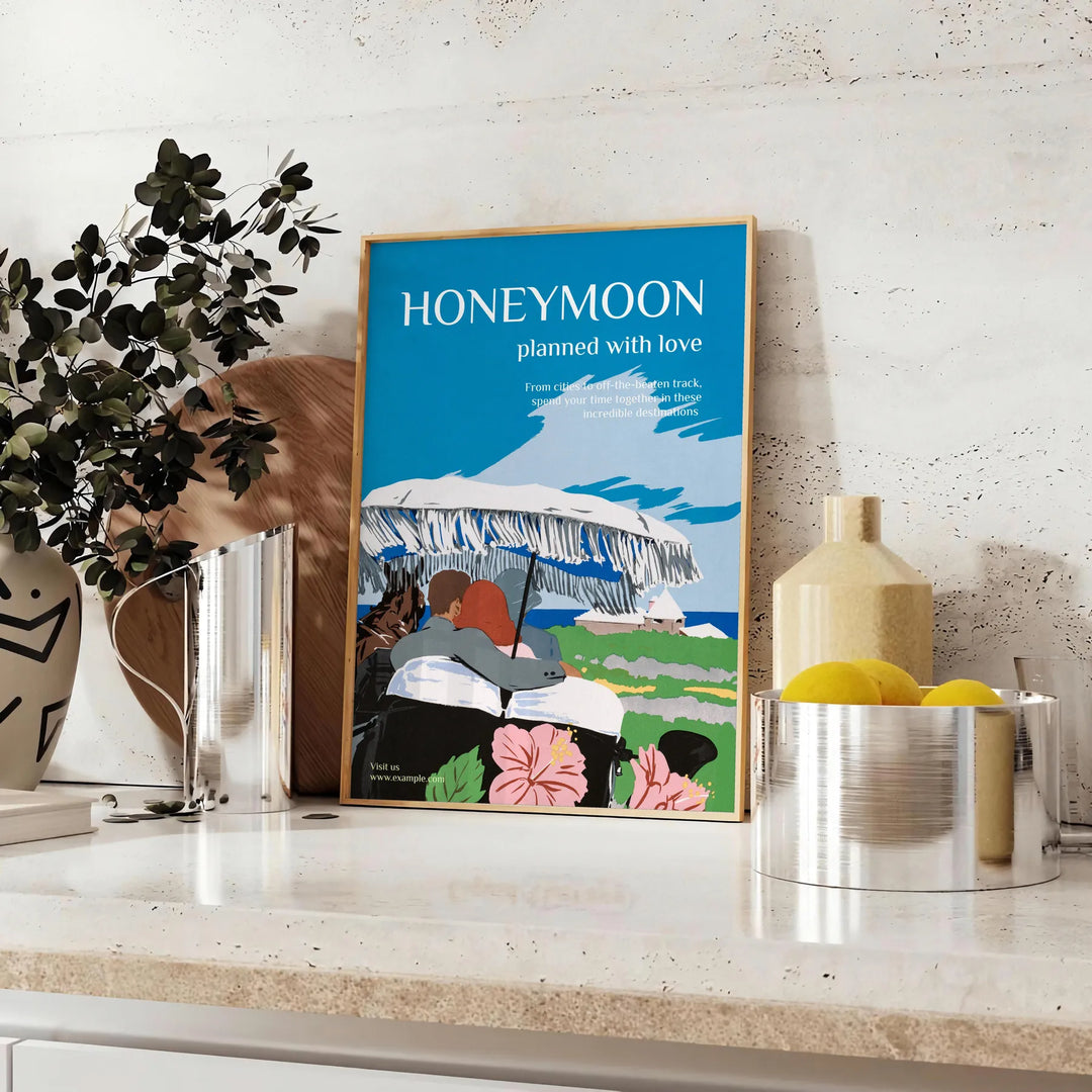 A romantic travel poster featuring a couple on a honeymoon, with blue and black tones. - styled on a counter with eucalyptus and a bowl of lemons