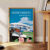 A romantic travel poster featuring a couple on a honeymoon, with blue and black tones. - beside a round wooden side table with books