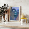 Abstract representation of a human figure in bold colors and shapes - styled on a counter with eucalyptus and a bowl of lemons