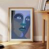 Abstract representation of a human figure in bold colors and shapes - beside a round wooden side table with books