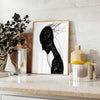 Abstract human figure in bohemian style with gray and black tones - styled on a counter with eucalyptus and a bowl of lemons