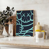 Abstract design featuring bold black and blue shapes with dynamic energy - styled on a counter with eucalyptus and a bowl of lemons