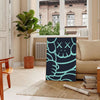 Abstract design featuring bold black and blue shapes with dynamic energy - in a Parisian living room with a sofa and a fig plant