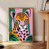 A jaguar in a lush green jungle, showcasing rich browns and greens - beside a round wooden side table with books