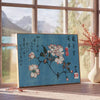 Abstract representation of Japan with bold black and orange colors - beside a round wooden side table with books