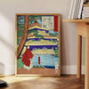 Traditional Japanese landscape featuring serene mountains and cherry blossoms in soft gray and blue tones - beside a round wooden side table with books