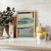 A serene landscape featuring lush green hills and a blue sky in Japan - styled on a counter with eucalyptus and a bowl of lemons