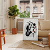Dynamic jazz dancers in motion against an orange and white background - in a Parisian living room with a sofa and a fig plant