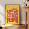 Retro-style illustration with flowing text in yellow and green hues - beside a round wooden side table with books