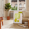 Colorful kitchen scene with green and orange elements, culinary theme - in a Parisian living room with a sofa and a fig plant