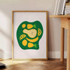 A modern kitchen scene featuring green and white colors with minimalist design elements - beside a round wooden side table with books